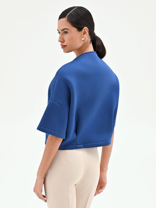 Capospalla cropped blu brillante con zip dorate