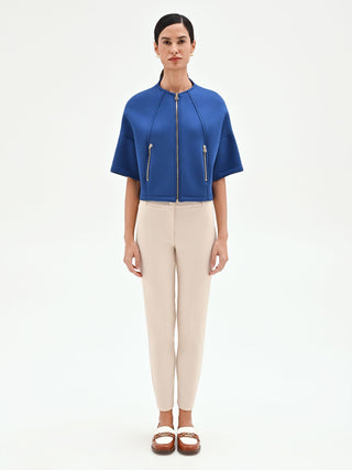 Capospalla cropped blu brillante con zip dorate