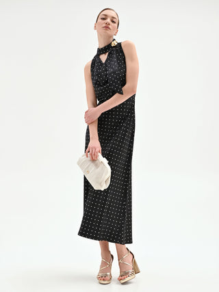 Abito nero a pois con collo drappeggiato