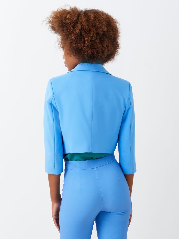 Short jacket with peak lapels Boxy, cropped, open-front jacket with peaked lapels. The garment is made in technical fabric from at least 25% recycled polyester. The jacket has 3/4 sleeves and two-toned monogram lining. The garment can be worn both as a classic jacket and as a shrug to pair with dresses and jumpsuits. The model is 1.73 m tall and wears size S. The garment is completely made in Italy. Rinascimento
