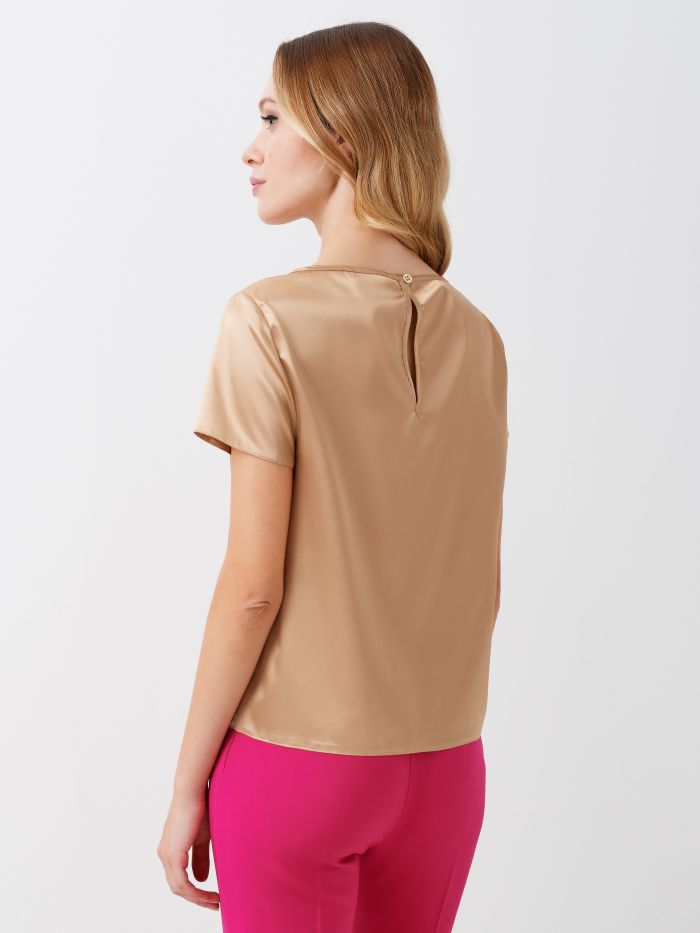 T-Shirt en satin couleur beige Blouse, modèle t-shirt boxy, à lignes épurées, en satin léger. Le t-shirt se portera facilement sous une veste ou pour donner une touche étincelante à vos looks de jour. Le mannequin mesure 1,76 m et porte une taille S. Ce vêtement a été entièrement fabriqué en Italie.  Rinascimento