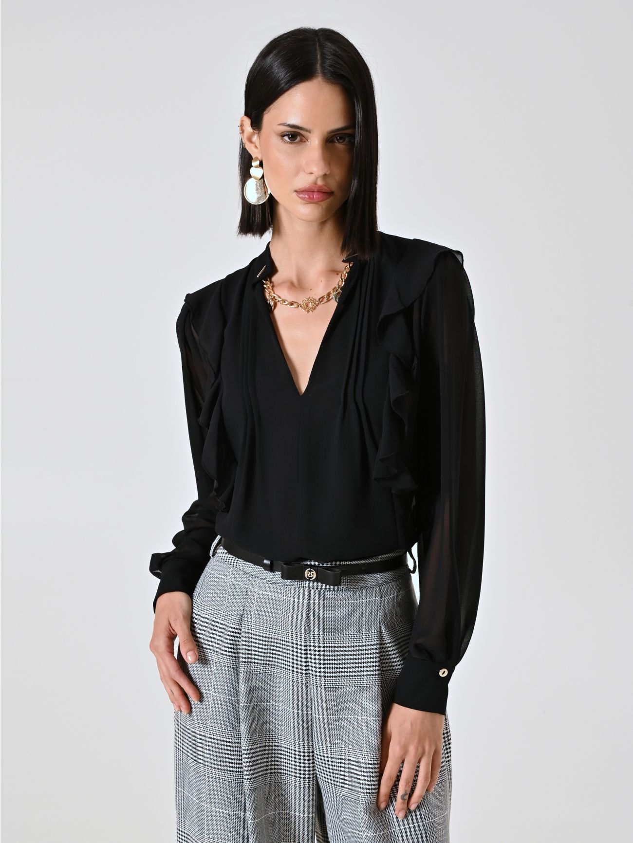 Bluse in Schwarz mit Rüschen und Goldkette in_i7