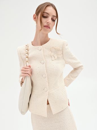 Chaqueta bouclé beige claro con flor aplicada